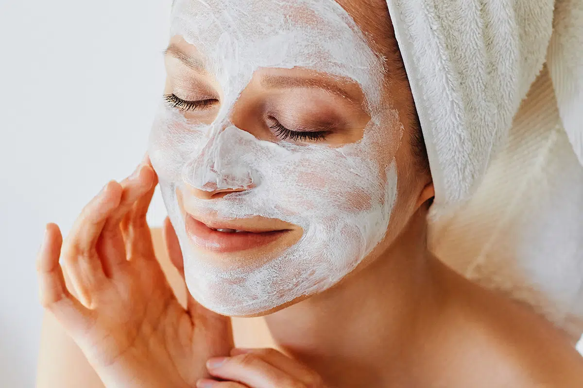 Beautiful young woman with facial mask on her face Beautiful young woman with facial mask on her face
